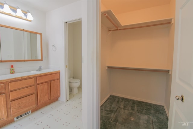 636 N Sterling St, Nampa, ID 83651 - bathroom with visible vents, a walk in closet, toilet, tile patterned floors, and vanity