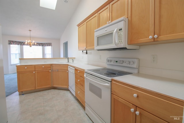 636 N Sterling St, Nampa, ID 83651 - kitchen with a sink, white appliances, a peninsula, an inviting chandelier, and light countertops