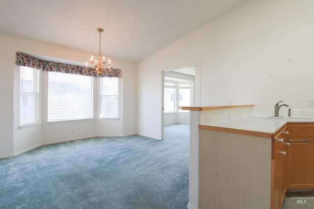 636 N Sterling St, Nampa, ID 83651 - kitchen with a wealth of natural light, light carpet, a sink, a chandelier, and vaulted ceiling
