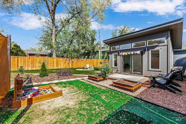 view of yard featuring fence and a vegetable garden
