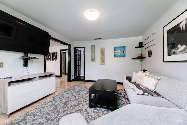 living area featuring visible vents and light wood-style floors