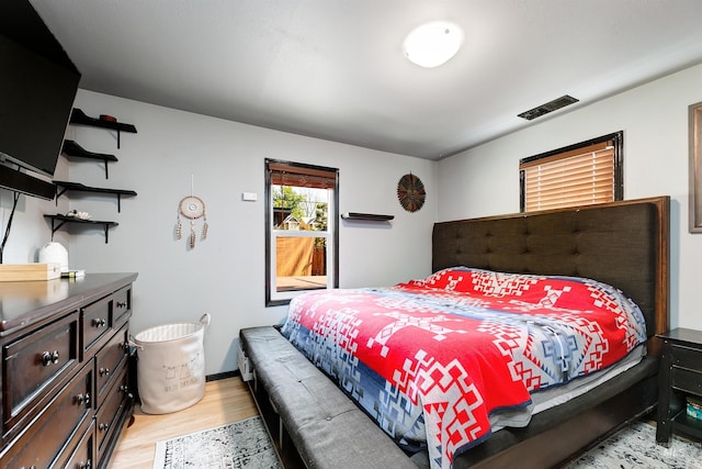bedroom featuring visible vents and light wood finished floors