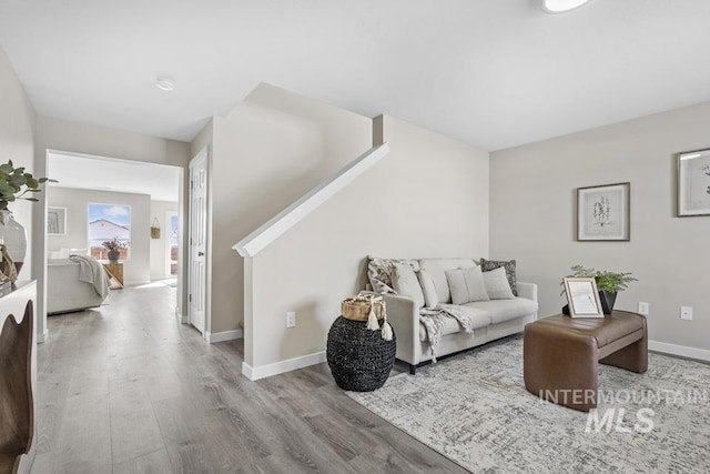 living area featuring wood finished floors and baseboards