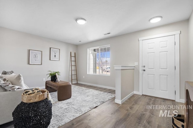 foyer with wood finished floors and baseboards