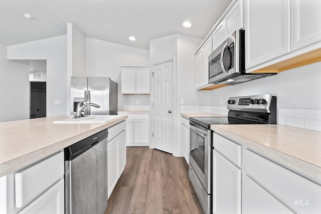 1773 E E Celbridge St, Nampa, ID 83686 - kitchen featuring appliances with stainless steel finishes, light countertops, white cabinets, light wood-type flooring, and recessed lighting