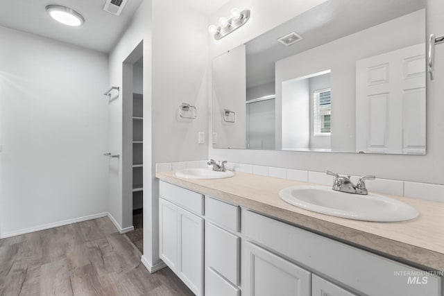 1773 E E Celbridge St, Nampa, ID 83686 - full bath with a stall shower, double vanity, wood finished floors, and a walk in closet