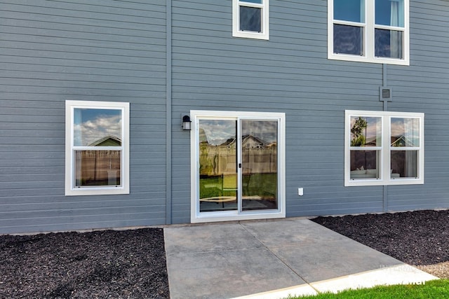 property entrance featuring a patio area