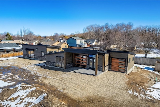 362 W London St, Middleton, ID 83644 - snow covered property with stone siding, fence, and a residential view