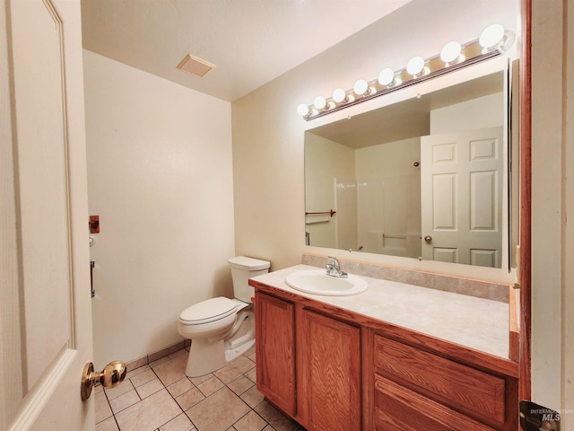 bathroom with walk in shower, vanity, toilet, and tile patterned floors