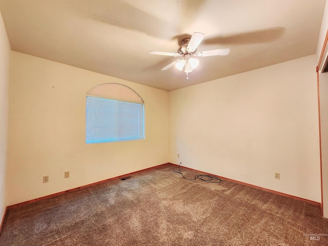 empty room with ceiling fan and carpet floors