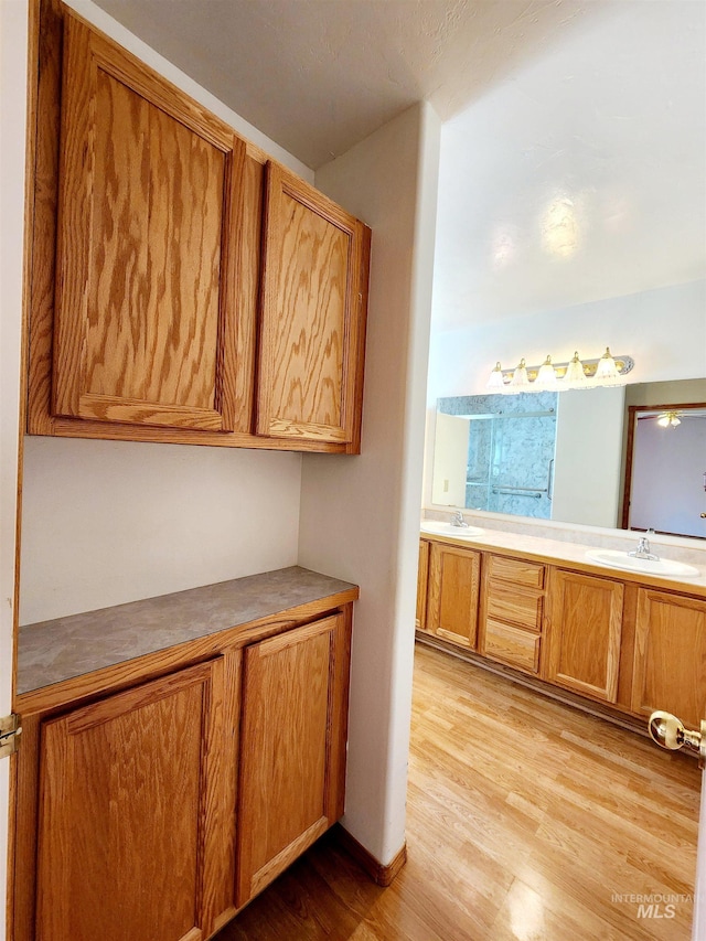 kitchen with light wood-type flooring and sink