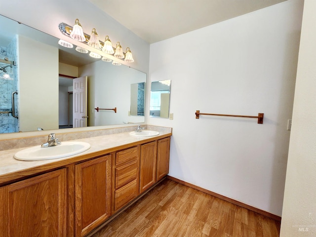 bathroom with hardwood / wood-style floors, an enclosed shower, and vanity