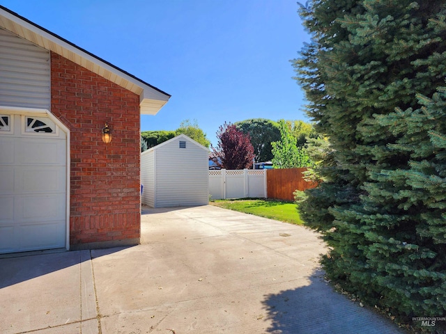 exterior space featuring a garage and a lawn