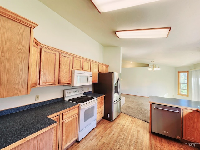 kitchen featuring an inviting chandelier, appliances with stainless steel finishes, and light hardwood / wood-style floors