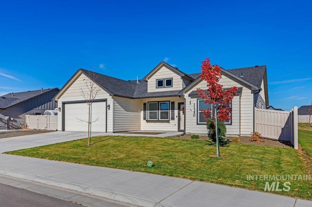 view of front of property with a garage and a front lawn