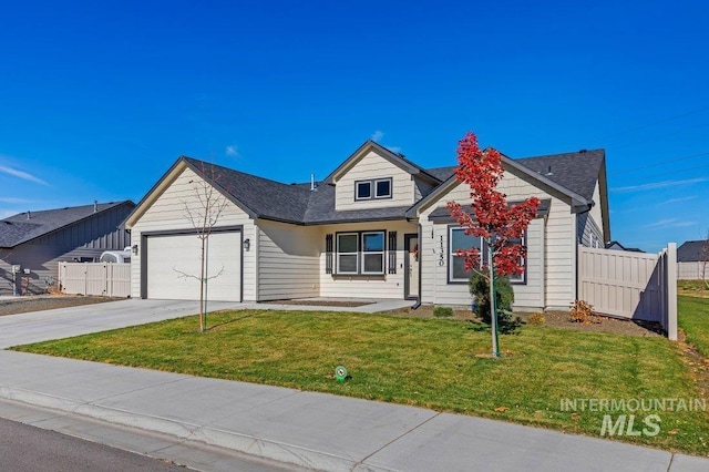 view of front of property with a garage and a front lawn