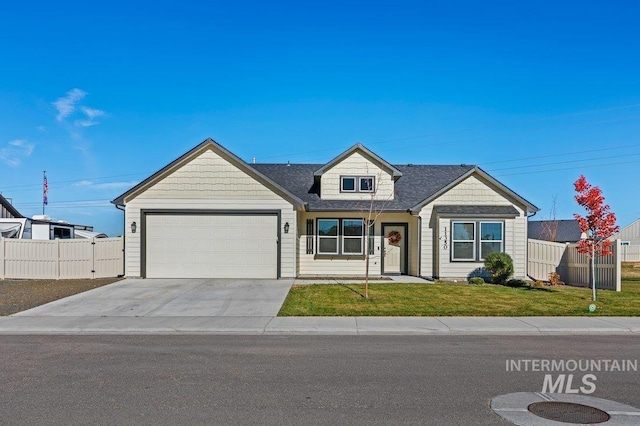 view of front of property with a front yard and a garage