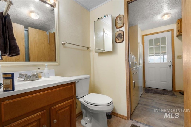 bathroom featuring vanity, baseboards, a textured ceiling, toilet, and wood finished floors