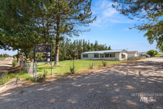 manufactured / mobile home with a front lawn, driveway, and a fenced front yard