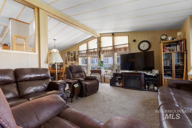 carpeted living area featuring wood walls and vaulted ceiling with beams