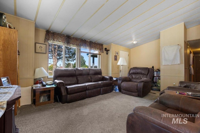 living area featuring carpet floors and wood walls