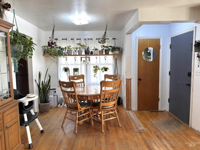 dining area with hardwood / wood-style floors