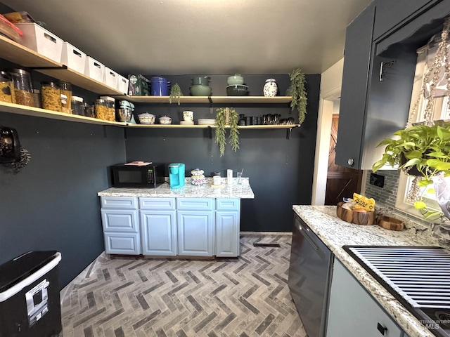 kitchen featuring light stone counters and dishwasher