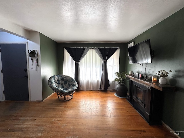 sitting room with light hardwood / wood-style floors and a textured ceiling