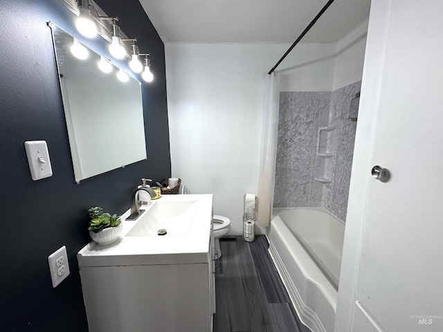 full bathroom featuring vanity, tub / shower combination, hardwood / wood-style floors, and toilet