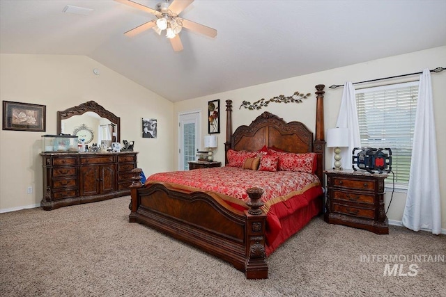 carpeted bedroom with ceiling fan and vaulted ceiling