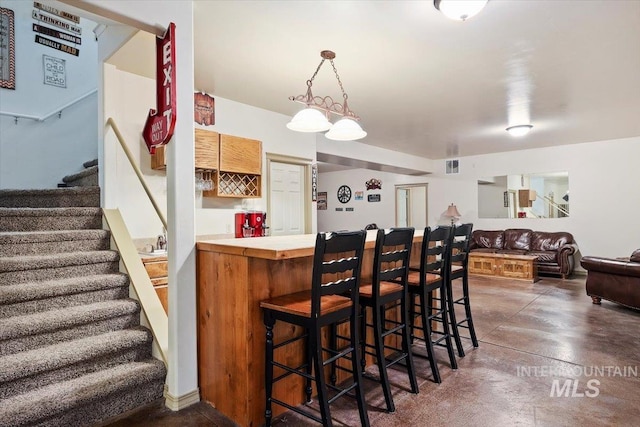 dining area featuring bar area