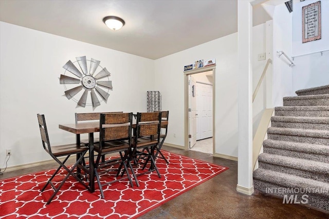 dining space featuring concrete floors