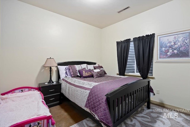 bedroom with dark carpet