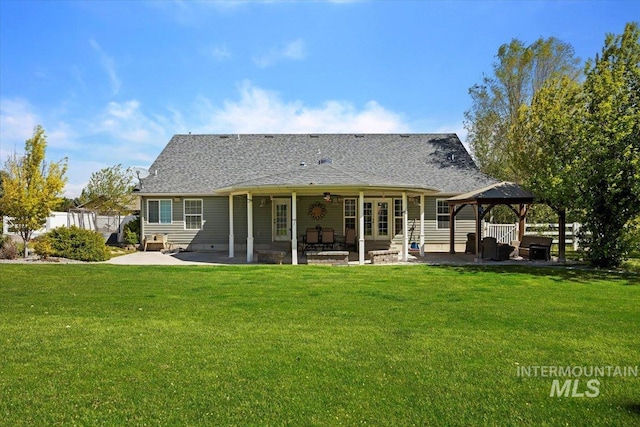 back of property featuring a patio area, a gazebo, and a lawn