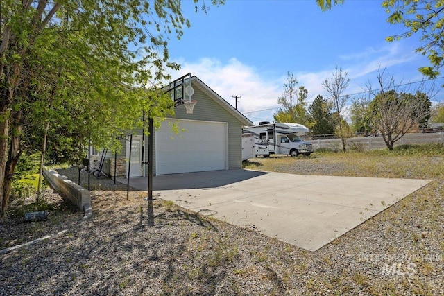 view of home's exterior with a garage and an outdoor structure