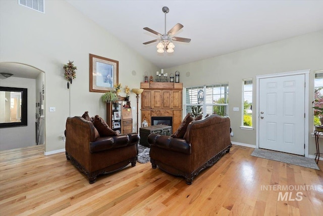 living room with high vaulted ceiling, ceiling fan, and light hardwood / wood-style floors