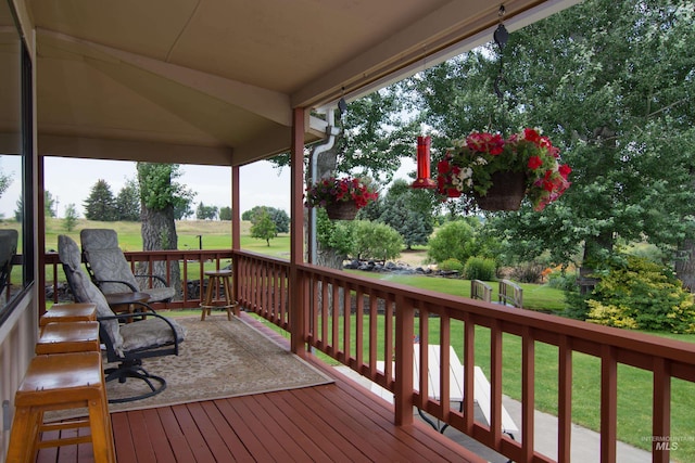 wooden deck featuring a yard