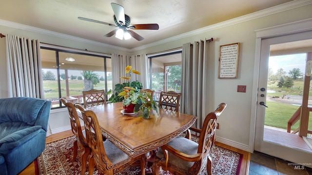dining area featuring ornamental molding, baseboards, and a ceiling fan