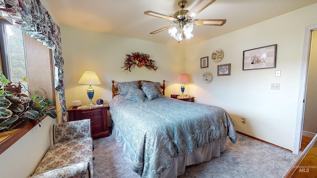 bedroom with carpet, a ceiling fan, and baseboards