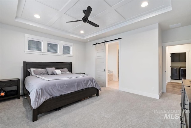 bedroom featuring coffered ceiling, ceiling fan, a barn door, connected bathroom, and light colored carpet