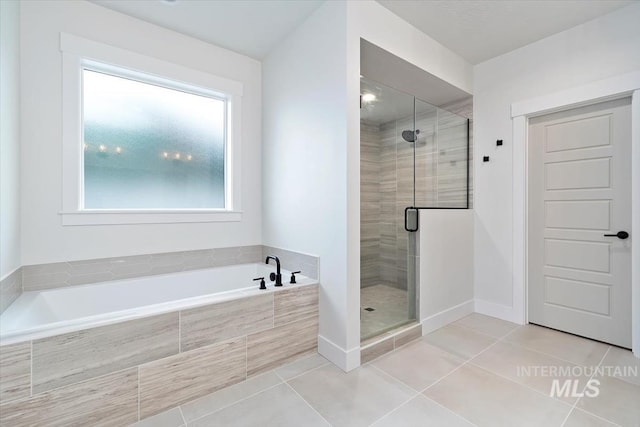 bathroom featuring tile patterned flooring and plus walk in shower