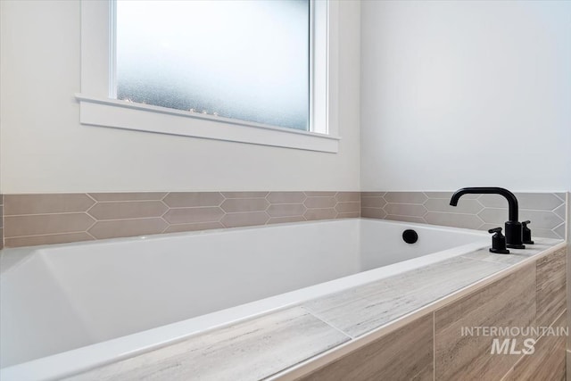 bathroom with tiled bath