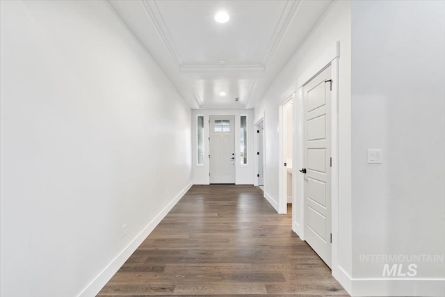 hallway featuring dark hardwood / wood-style flooring and ornamental molding