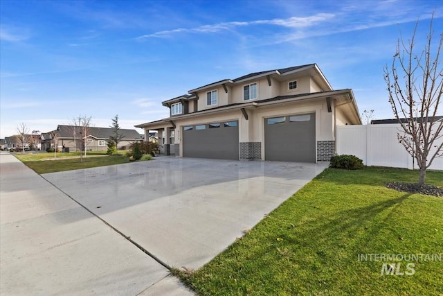 view of front of home with a front yard and a garage