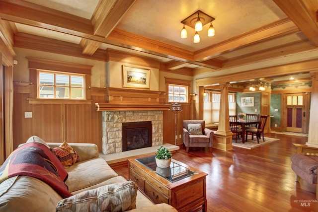 living room with ornate columns, wooden walls, a fireplace, and coffered ceiling