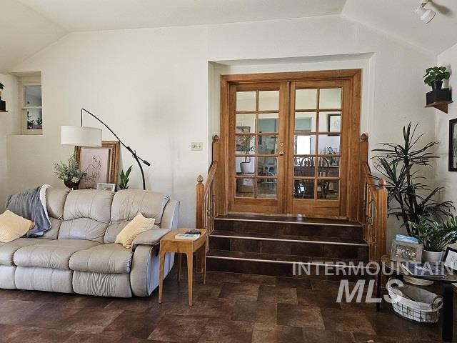 living room featuring french doors and lofted ceiling