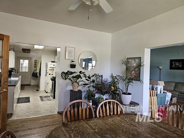 dining space featuring ceiling fan and light tile patterned flooring