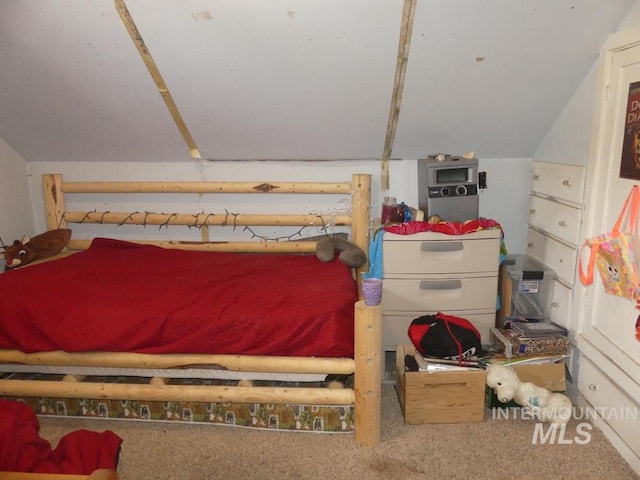 bedroom featuring carpet floors and lofted ceiling