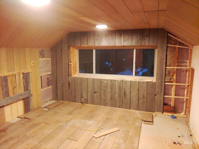 bonus room featuring wooden ceiling, wood-type flooring, wooden walls, and vaulted ceiling