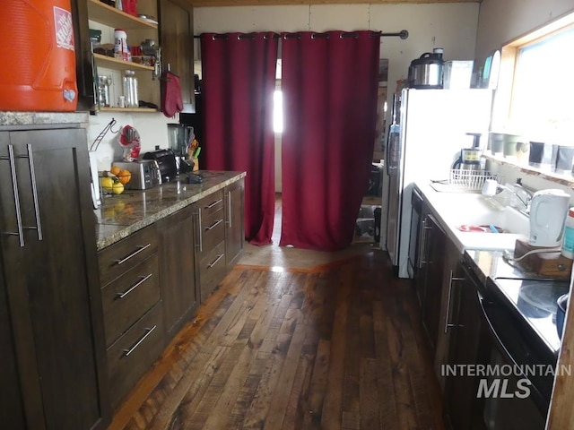 kitchen featuring dark hardwood / wood-style flooring, light stone countertops, and sink